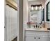 Simple bathroom with a white vanity, a shower, and a window at 1202 Prince William Rd., North Myrtle Beach, SC 29582