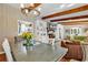 Dining area with wood beams, chandelier, and view into living room at 1202 Prince William Rd., North Myrtle Beach, SC 29582