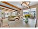 Bright dining area with wood beams, chandelier, and view to living room at 1202 Prince William Rd., North Myrtle Beach, SC 29582