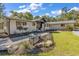 Charming ranch home with landscaped yard and a metal bench at 1202 Prince William Rd., North Myrtle Beach, SC 29582