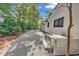 White brick home with a gravel pathway and mature trees at 1202 Prince William Rd., North Myrtle Beach, SC 29582