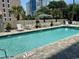 Community pool with surrounding patio furniture at 7509 N Ocean Blvd. # 104, Myrtle Beach, SC 29572