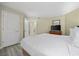 Bright bedroom with a king-size bed, dresser with TV, and access to other rooms at 201 S Ocean Blvd. # 1005, Myrtle Beach, SC 29577