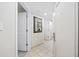 Bright hallway featuring tile flooring, white doors, and a stylish mirror, leading to a comfortable living space at 201 S Ocean Blvd. # 1005, Myrtle Beach, SC 29577