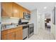 A modern kitchen with light wood cabinets and stainless steel appliances in a condo at 201 S Ocean Blvd. # 1005, Myrtle Beach, SC 29577