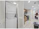 Convenient in-unit laundry area with a stacked washer and dryer, along with additional storage and a partial view of the kitchen at 201 S Ocean Blvd. # 1005, Myrtle Beach, SC 29577
