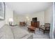 Spacious living room with modern flooring, a dining table, comfortable sofa, and entertainment center at 201 S Ocean Blvd. # 1005, Myrtle Beach, SC 29577