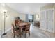 Comfortable open-concept living space featuring a dining area with seating for four and access to a private balcony at 201 S Ocean Blvd. # 1005, Myrtle Beach, SC 29577