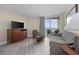 Cozy living room with comfortable seating, a TV, and a sliding glass door leading to a balcony with ocean views at 201 S Ocean Blvd. # 1005, Myrtle Beach, SC 29577