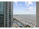 Beautiful ocean and beach view from condo showcasing the building, pier, beach and outdoor pool at 201 S Ocean Blvd. # 1005, Myrtle Beach, SC 29577