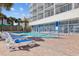 Enjoy the community pool, surrounded by lounge chairs and tropical landscaping at 201 S Ocean Blvd. # 1005, Myrtle Beach, SC 29577