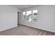 Bedroom features neutral walls, carpet, three windows, and access to other rooms at 126 Hancher Dr., Myrtle Beach, SC 29588