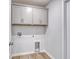 Bright laundry room with wooden floors and white cabinets above the units at 126 Hancher Dr., Myrtle Beach, SC 29588