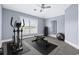Bright exercise room with window, carpet flooring, weights, elliptical machine, and workout bench at 1533 Biltmore Dr., Myrtle Beach, SC 29579