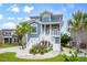 Inviting coastal home featuring a blue exterior, white trim, and lush tropical landscaping at 1533 Biltmore Dr., Myrtle Beach, SC 29579