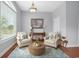 Bright and airy living room with hardwood floors, neutral furniture, and a large window for ample light at 1533 Biltmore Dr., Myrtle Beach, SC 29579