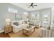 Comfortable living room with a plush sofa, striped chairs, and natural light creating a relaxing atmosphere at 1533 Biltmore Dr., Myrtle Beach, SC 29579