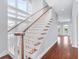 Elegant staircase with wood and white finishes leads to the second floor and floods the home with natural light at 1533 Biltmore Dr., Myrtle Beach, SC 29579
