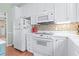 White kitchen with stainless steel appliances and wood floors at 4333 Windy Heights Dr., North Myrtle Beach, SC 29582