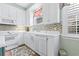 Bright white kitchen features an island and stainless steel appliances at 4333 Windy Heights Dr., North Myrtle Beach, SC 29582