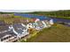 Aerial view of waterfront houses showcasing multiple decks, offering a glimpse of the outdoor living spaces by the water at 4524 Landing Rd., Little River, SC 29566