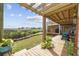 Relaxing backyard deck with a pergola, string lights, and views of the water and marsh, perfect for outdoor living at 4524 Landing Rd., Little River, SC 29566
