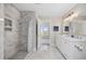 Updated bathroom with marble floors, vanity, shower with pebble floor, and water views at 4524 Landing Rd., Little River, SC 29566