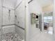 Luxurious walk-in shower with bench and elegant tile work, plus a view to the bedroom at 4524 Landing Rd., Little River, SC 29566