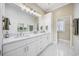 Elegant bathroom featuring double sinks, white cabinets, a large mirror, and modern lighting at 4524 Landing Rd., Little River, SC 29566