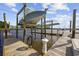 Boat lift on a pier, supporting a boat above the water, providing convenience for boat owners at 4524 Landing Rd., Little River, SC 29566