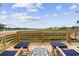 Relax and enjoy the waterfront view from this deck with outdoor lounge chairs and a table at 4524 Landing Rd., Little River, SC 29566