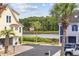 Charming waterfront property with palm trees and an American flag waving in the yard at 4524 Landing Rd., Little River, SC 29566