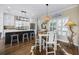 Open concept kitchen and dining area with a large island, modern lighting, and luxury finishes at 4524 Landing Rd., Little River, SC 29566