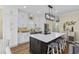 Bright, modern kitchen with a large island, white cabinetry, stainless appliances, and decorative accents at 4524 Landing Rd., Little River, SC 29566