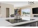 Gourmet kitchen features white marble countertops, stainless steel pot, and an electric cooktop at 4524 Landing Rd., Little River, SC 29566