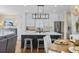 Modern kitchen with a large island, white cabinets, stainless steel appliances, and stylish lighting at 4524 Landing Rd., Little River, SC 29566