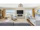 Cozy living room featuring a fireplace, comfortable seating, and a large window with marina views at 4524 Landing Rd., Little River, SC 29566