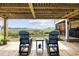 Covered patio with outdoor furniture, string lights, and views of the marsh at 4524 Landing Rd., Little River, SC 29566
