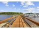 Wooden pier extending into the water, surrounded by boats and docks, offering direct water access and scenic views at 4524 Landing Rd., Little River, SC 29566