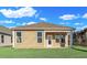 New home features an exterior view of the backyard with green grass and a light beige color at 626 Castle Ct., Myrtle Beach, SC 29579