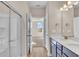 Stylish bathroom featuring double sink vanity and glass shower with view to bedroom at 626 Castle Ct., Myrtle Beach, SC 29579