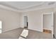 Spacious bedroom with neutral carpeting, tray ceiling, and two doorways to the bathroom and closet at 626 Castle Ct., Myrtle Beach, SC 29579