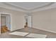 Spacious bedroom with carpet flooring, tray ceiling, and doors leading to closet and other rooms at 626 Castle Ct., Myrtle Beach, SC 29579