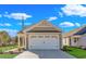 Exterior shot showcasing the home's two-car garage with white door and complementary landscaping at 626 Castle Ct., Myrtle Beach, SC 29579