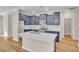Modern kitchen featuring navy cabinets, quartz countertops, stainless steel appliances and a kitchen island at 626 Castle Ct., Myrtle Beach, SC 29579