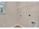 A utility room with wood floors has hookups for your washer and dryer and wire shelving at 626 Castle Ct., Myrtle Beach, SC 29579