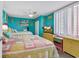 Charming bedroom featuring two beds, colorful accents, beach decor, and plenty of natural light from the windows at 7000 Ocean Blvd. N # 133, Myrtle Beach, SC 29572