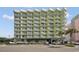 Modern condo building with balconies and beautiful landscaping in a popular vacation destination at 7000 Ocean Blvd. N # 133, Myrtle Beach, SC 29572