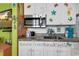 Modern kitchen showcasing stainless steel microwave, under-cabinet lighting and playful beach-themed decorations at 7000 Ocean Blvd. N # 133, Myrtle Beach, SC 29572