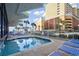 Relaxing outdoor pool area with lounge chairs, providing a refreshing escape in a sunny setting at 7000 Ocean Blvd. N # 133, Myrtle Beach, SC 29572